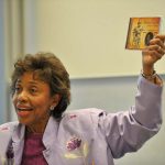 León holds up her CD
