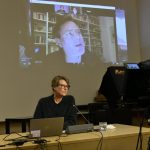 Rau speaks via Zoom connection, with Krauthausen in foreground