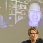 Rau speaks via Zoom connection, with Krauthausen in foreground