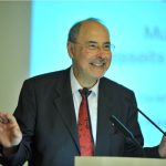 a smiling Danuser lectures from the podium