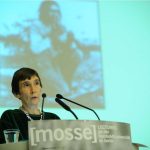 Romaine lectures from the podium