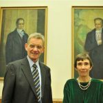 Romaine and Dietrich pose in front of the portraits of the Humboldt brothers
