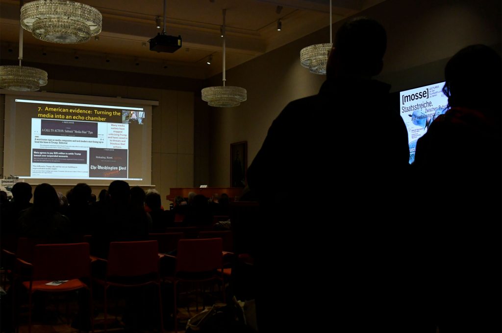 the audience looks on