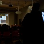 the audience looks on