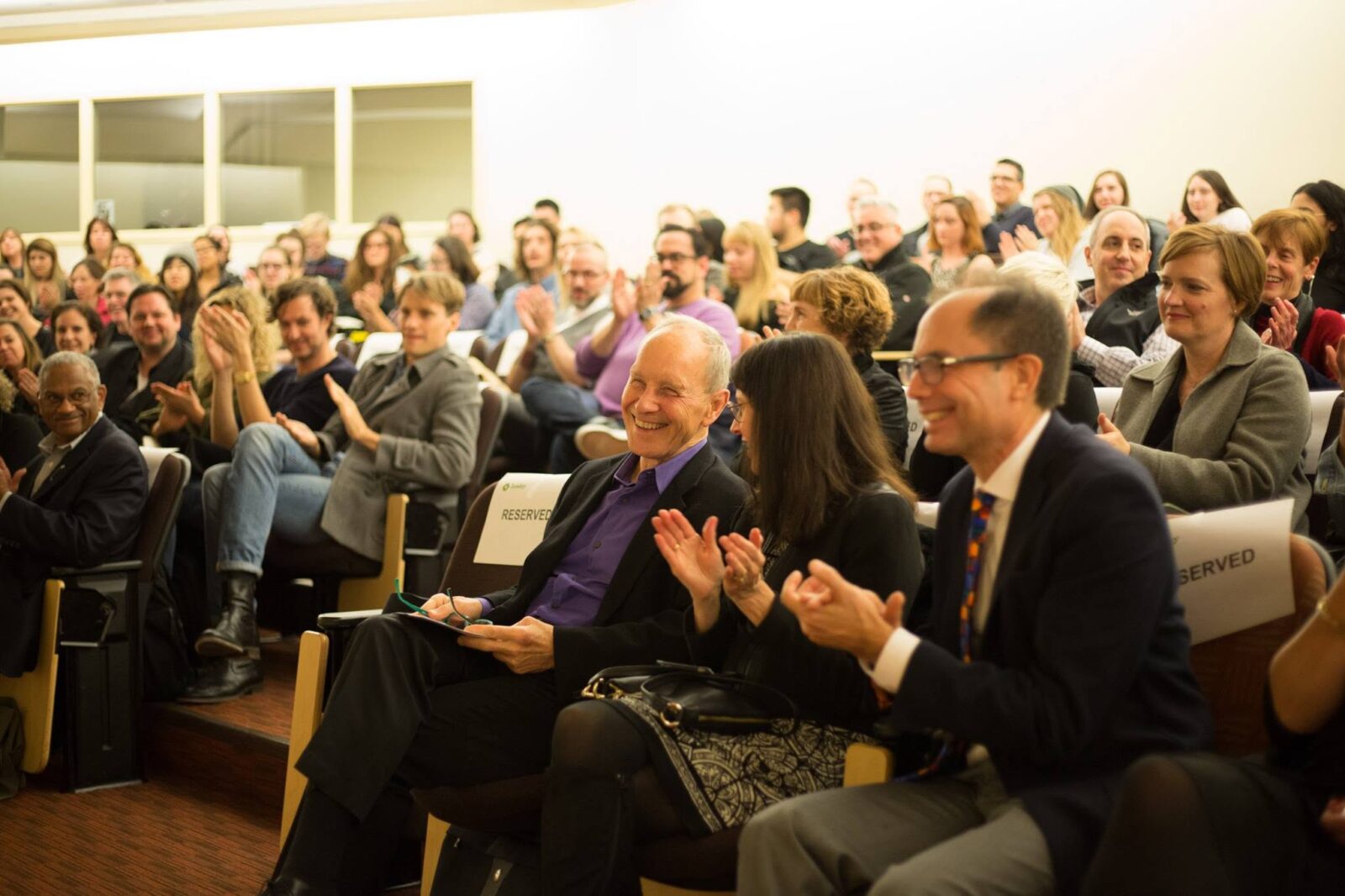 Dean Emeritus Stan Trecker, who retired from Lesley at the end of last week, is honored by an appreciative crowd, including trustee Hans Strauch (right) and his wife, Darisse Paquette.