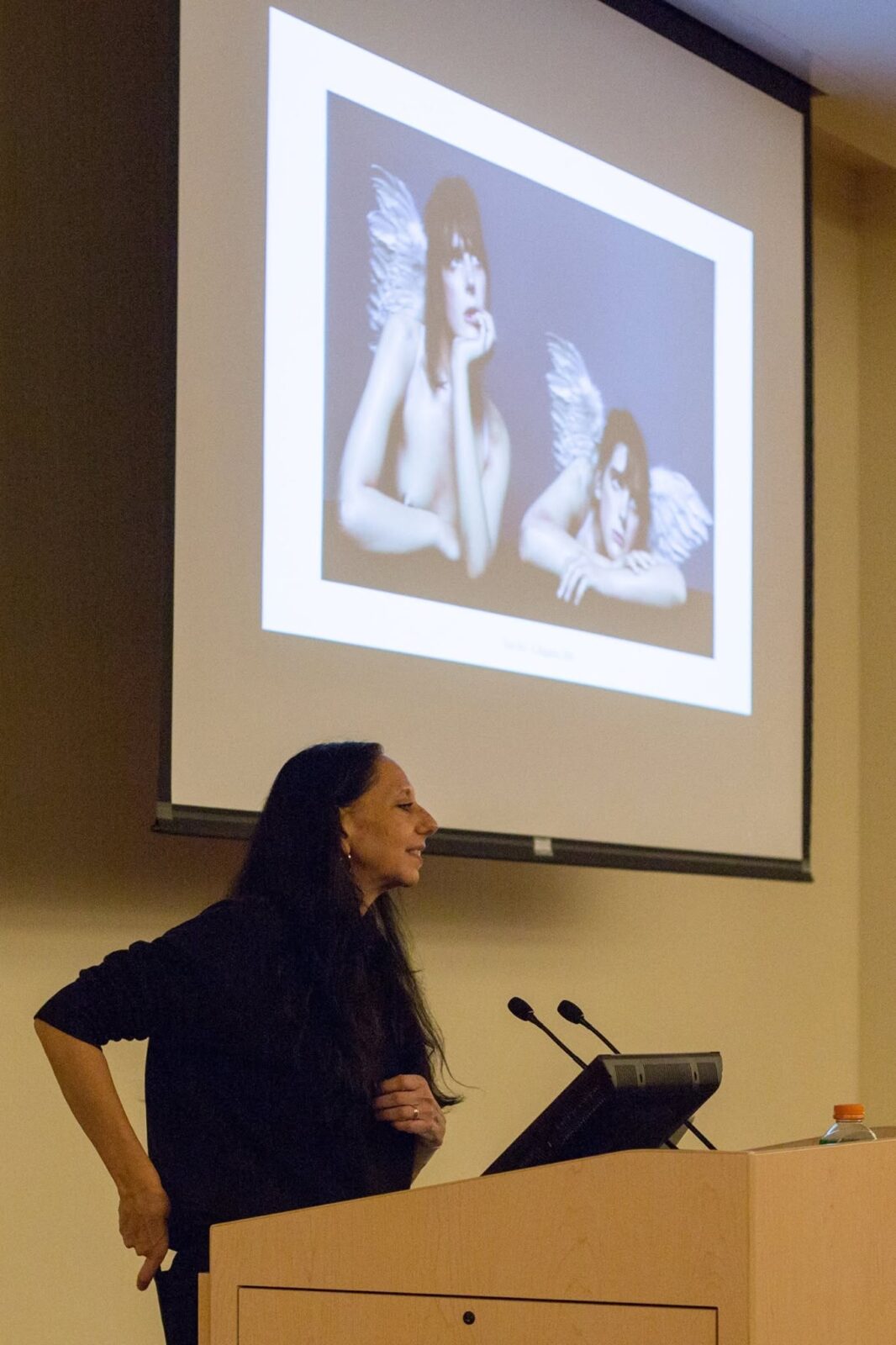 Inez speaking at a podium