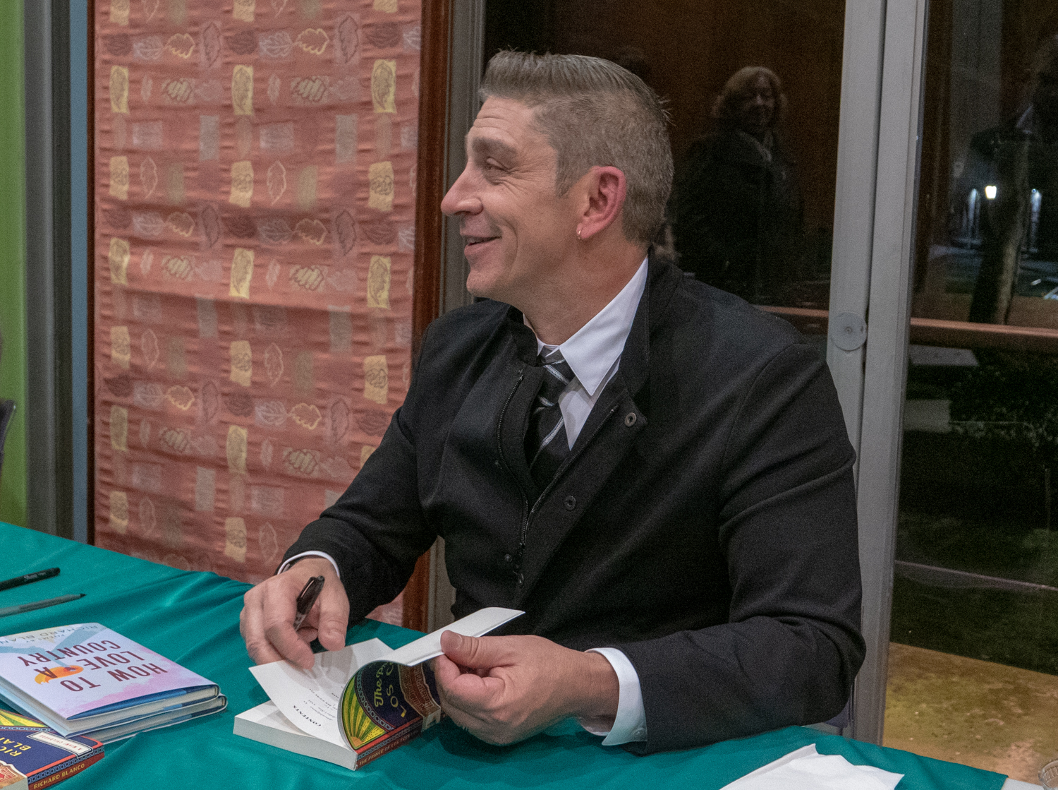 Richard Blanco signs a book after the lecture.
