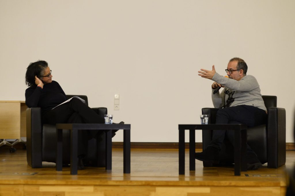a seated Kosky and de Mazza in conversation