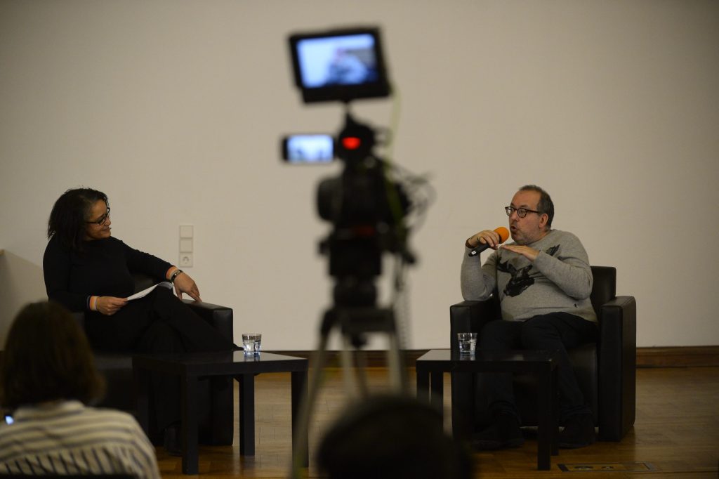 Kosky and de Mazza in conversation, with camera in foreground