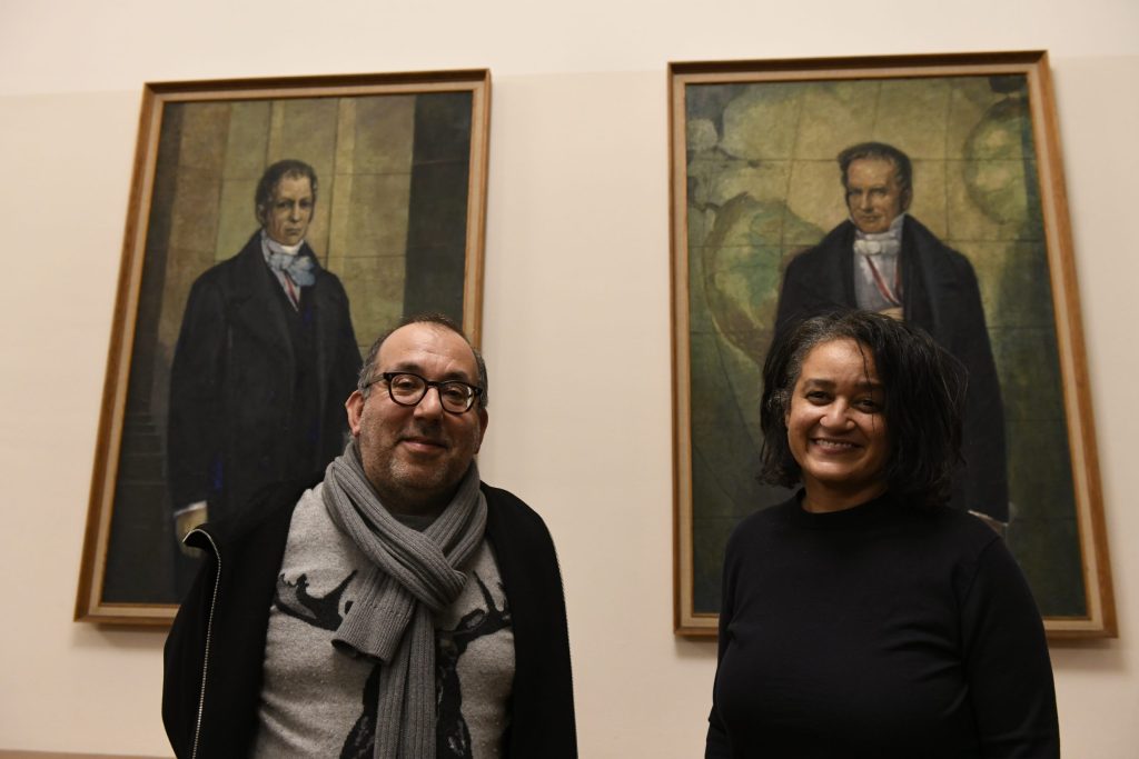 Kosky and de Mazza pose in front of the portraits of the Humboldt brothers
