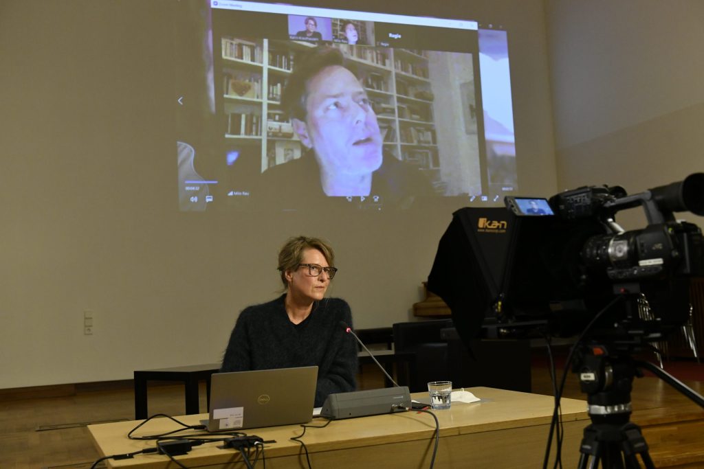 Rau speaks via Zoom connection, with Krauthausen in foreground