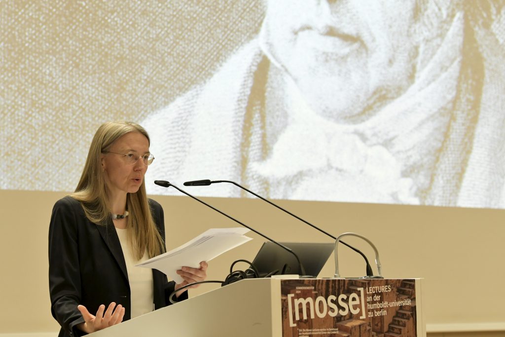 Auer speaking at the podium