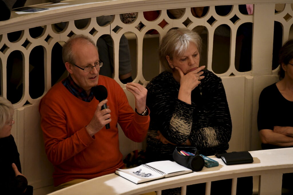 an audience member asks a question
