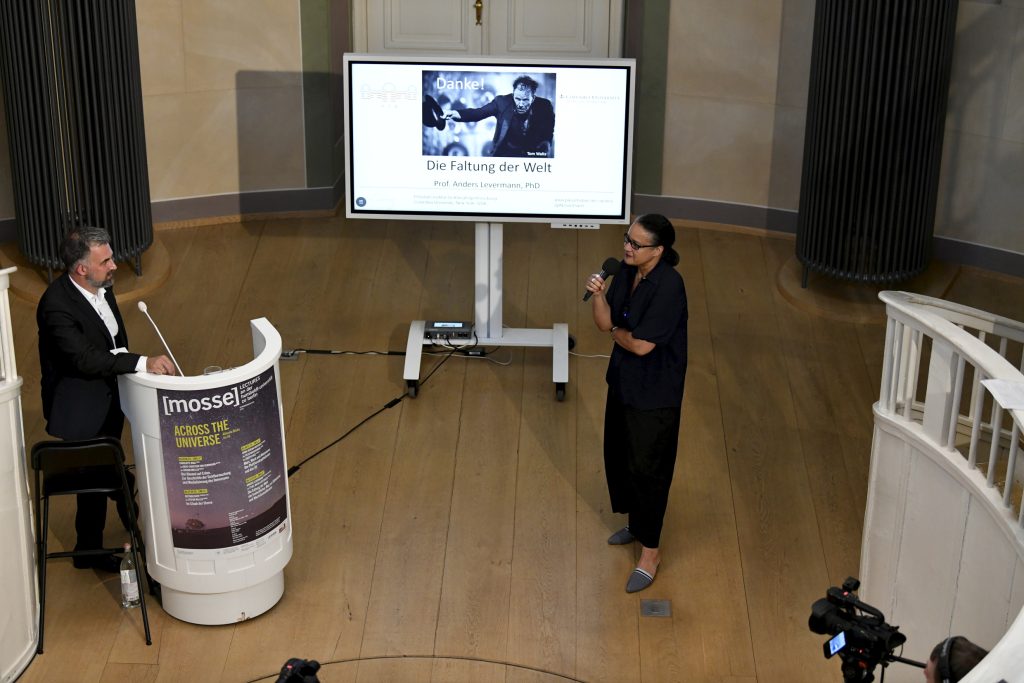 Ethel Matala de Mazza speaks in front of the screen