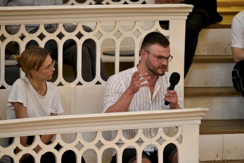 an audience member poses a question