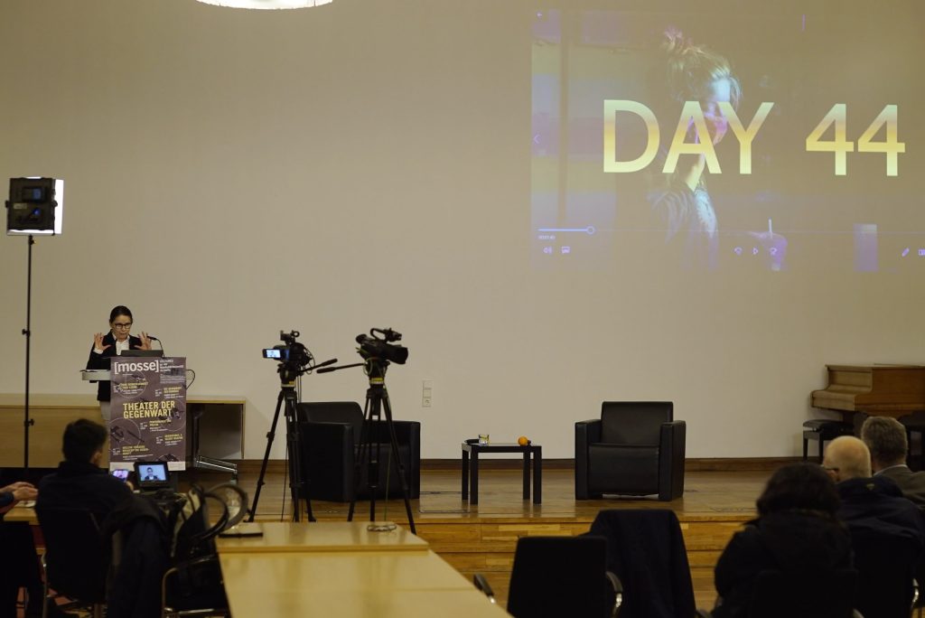 Enyedi speaks at the podium in front of the screen