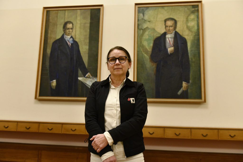 Enyedi poses in front of the portraits of the Humboldt brothers