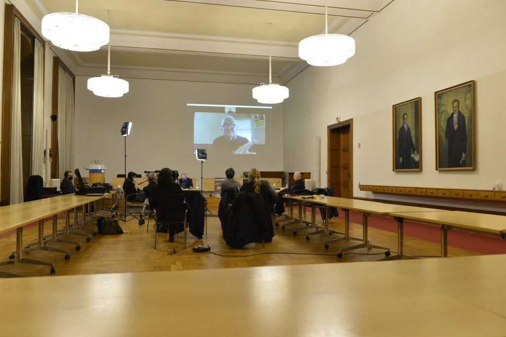 The room, with audience members and Gumbrecht joining virtually