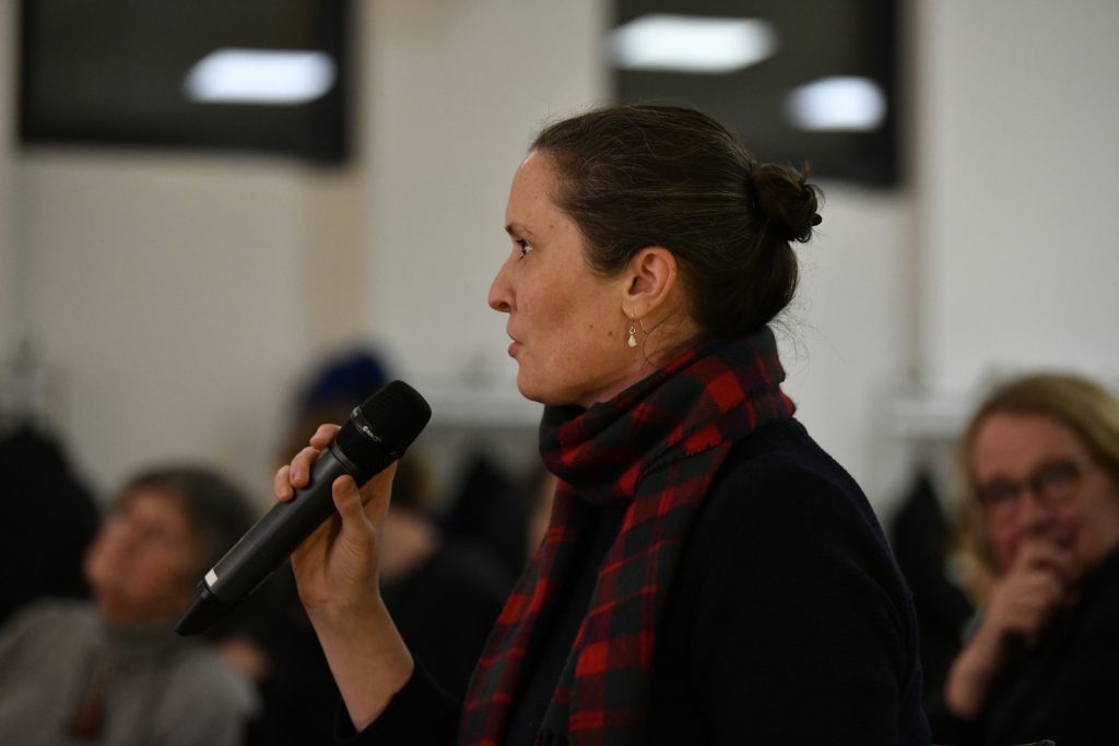An audience member asks a question