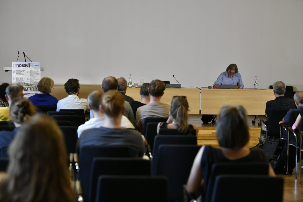 the audience listens intently