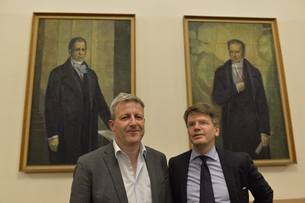 Möllers and Manow pose in front of portraits of the Humboldt brothers