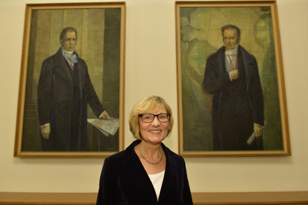 Naumann poses in front of the portraits of the Humboldt brothers