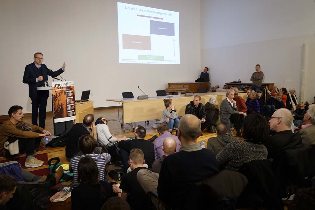 the audience listens to Reckwitz speaking at the podium