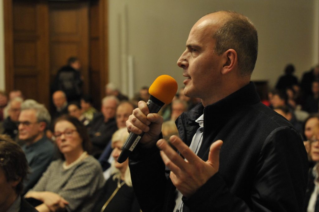 an audience member asks a question