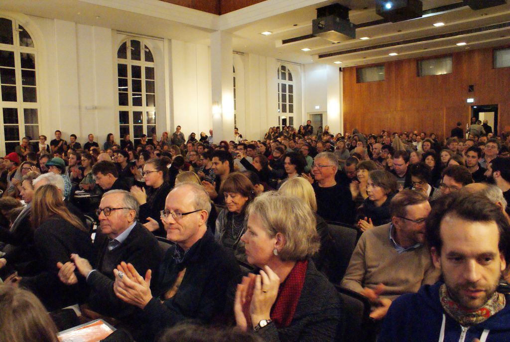 the audience looks on