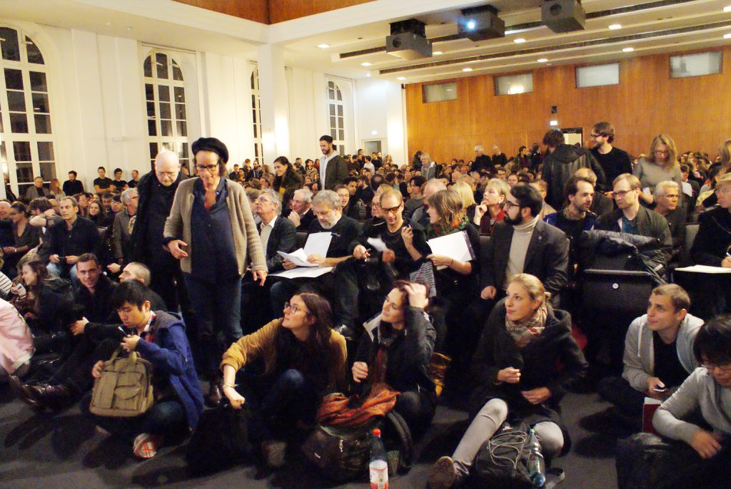 the audience looks on