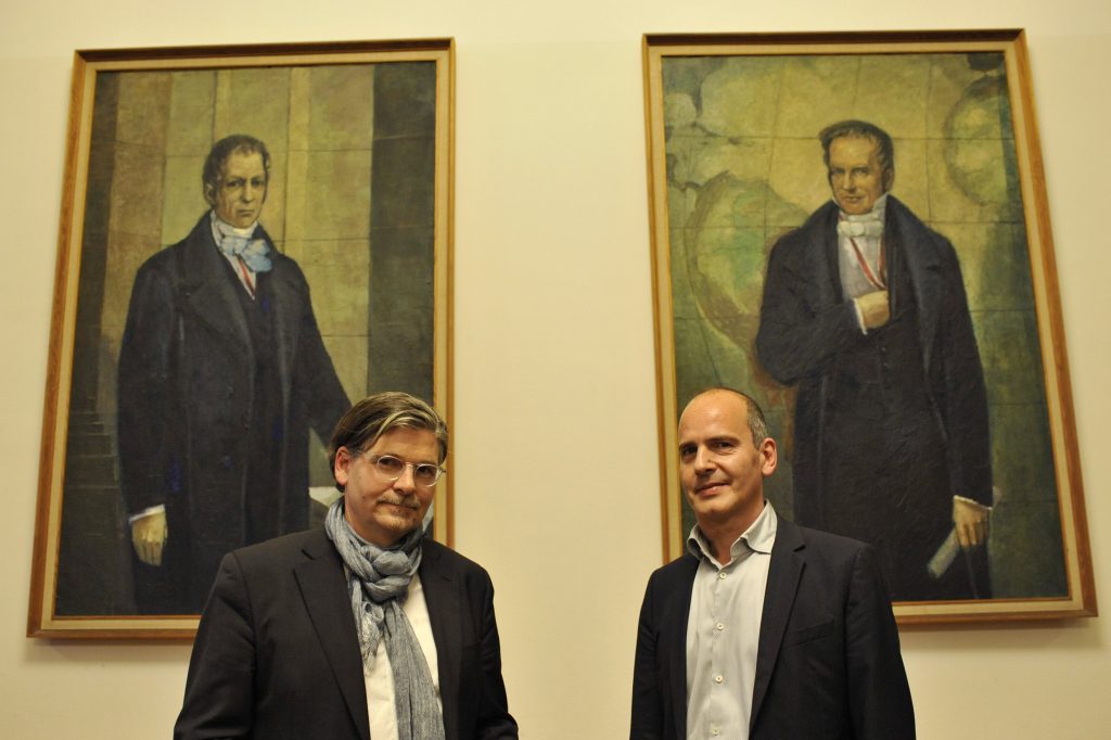 Jens Bisky and Jan-Werner Müller pose before the portraits of the Humboldt brothers