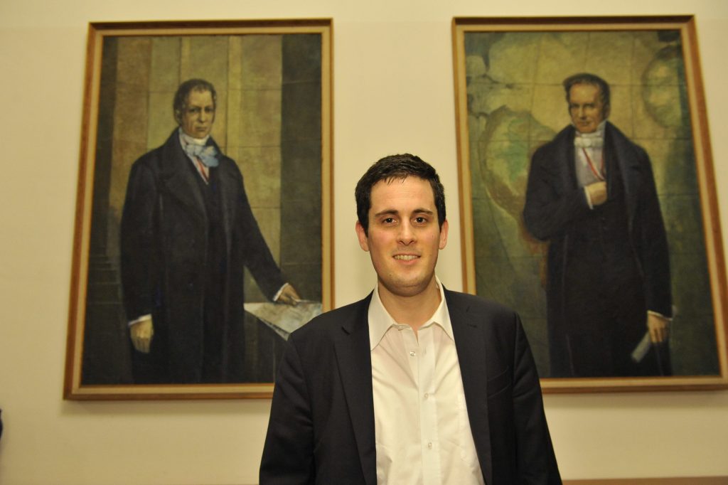 Wolf poses in front of the portraits of the Humboldt brothers