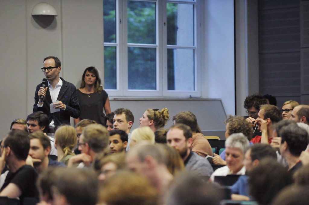 a full audience looks on