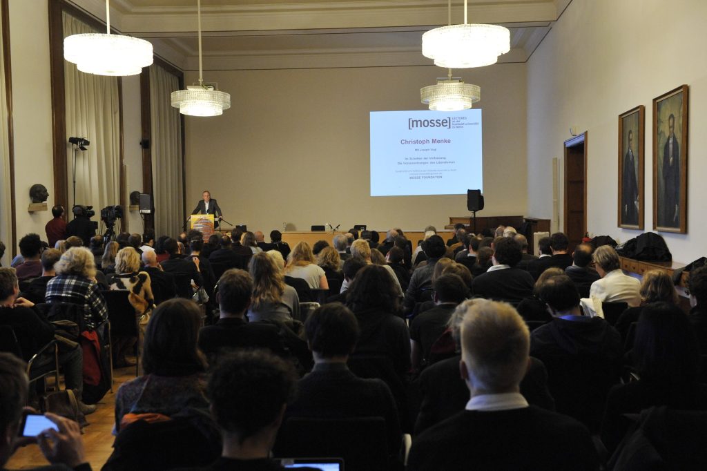 a full audience listens to the lecture