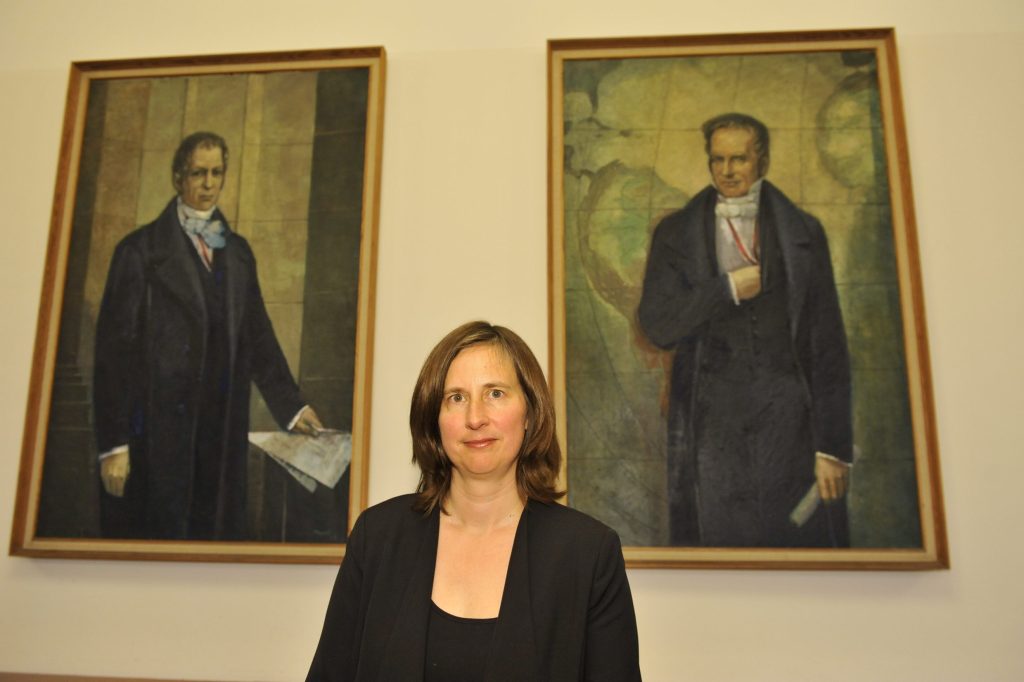 Röggla poses in front of the portraits of the Humboldt brothers