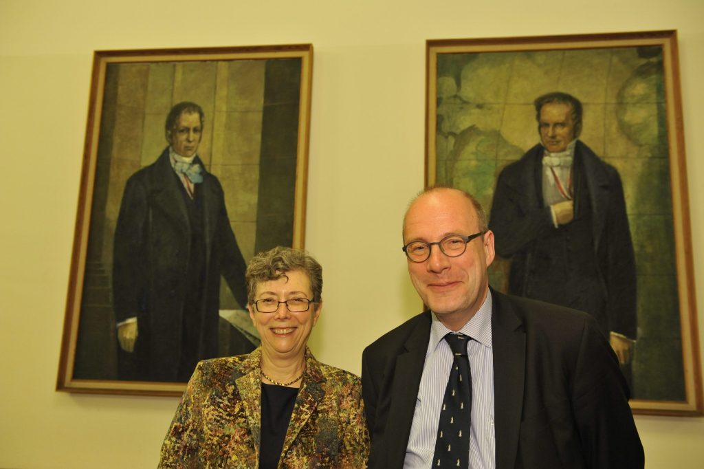 Stroumsa and Markschies pose in front of the portraits of the Humboldt brothers