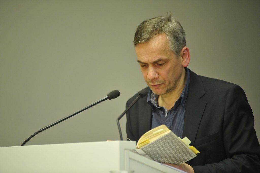 Seiler reads from the podium