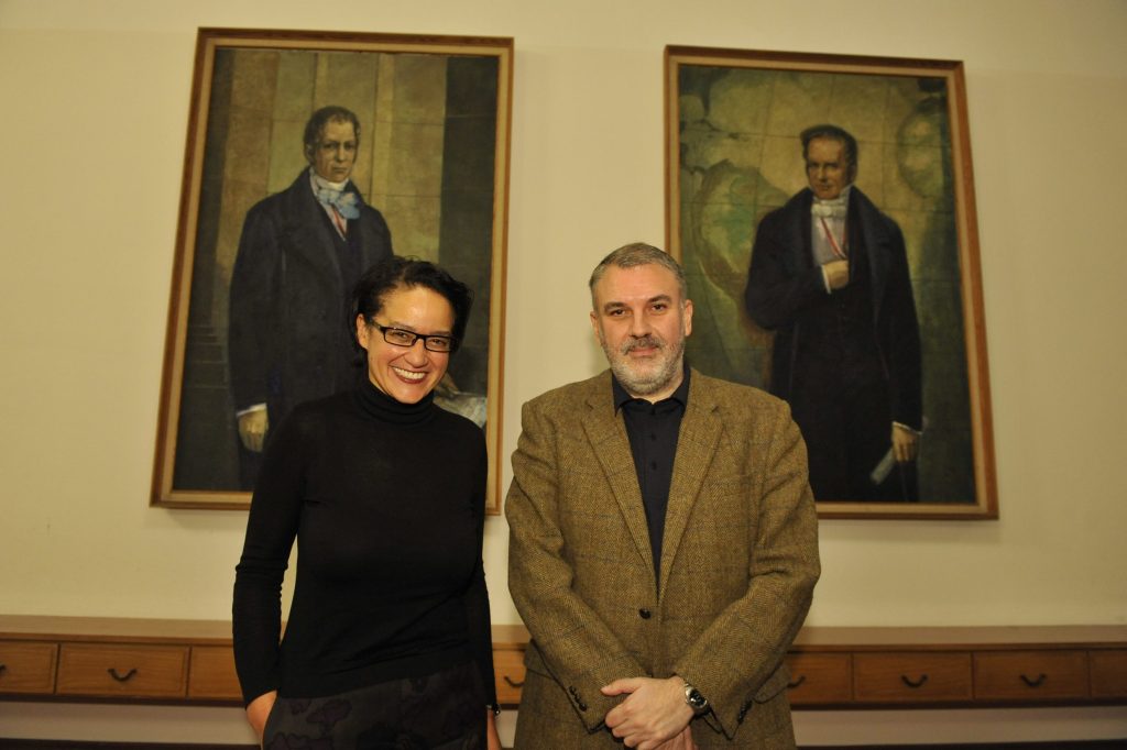Stavrakakis and de Mazza pose in front of the portraits of the Humboldt brothers
