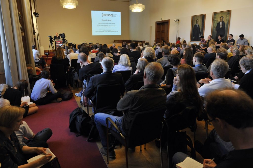 the audience watches the lecture