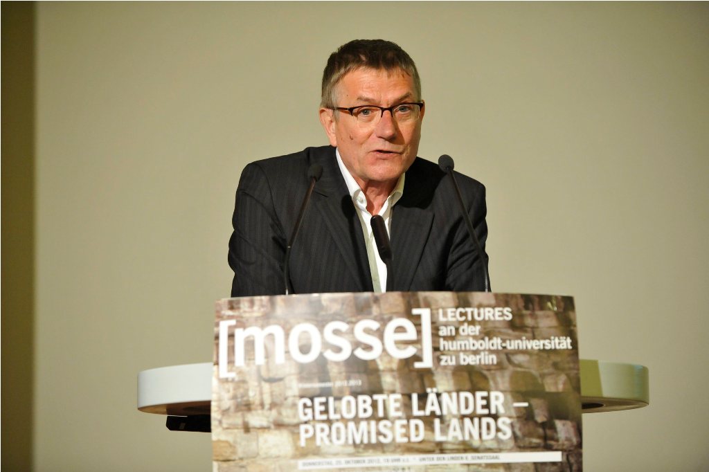 Armbruster lectures from the podium