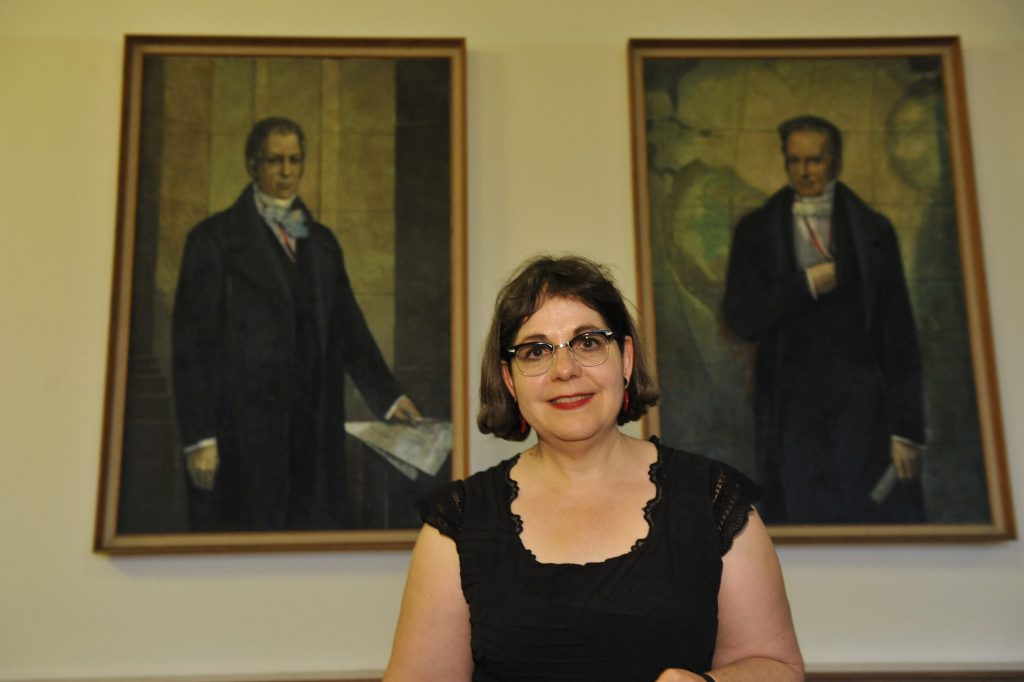 Bronfen poses in front of the portraits of the Humboldt brothers