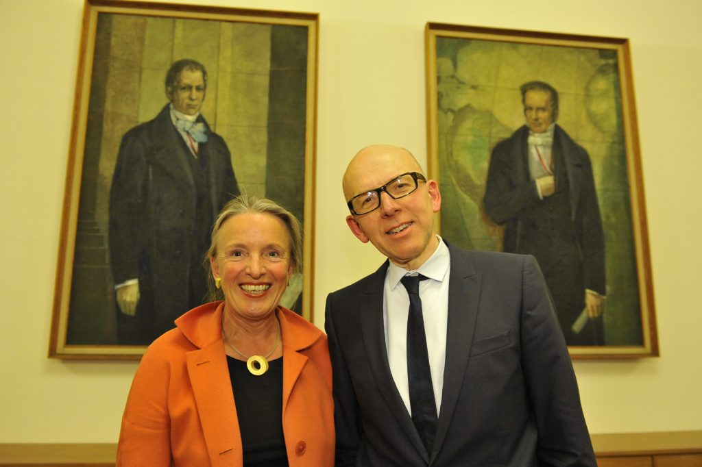 Bude and Frevert pose before the portraits of the Humboldt brothers