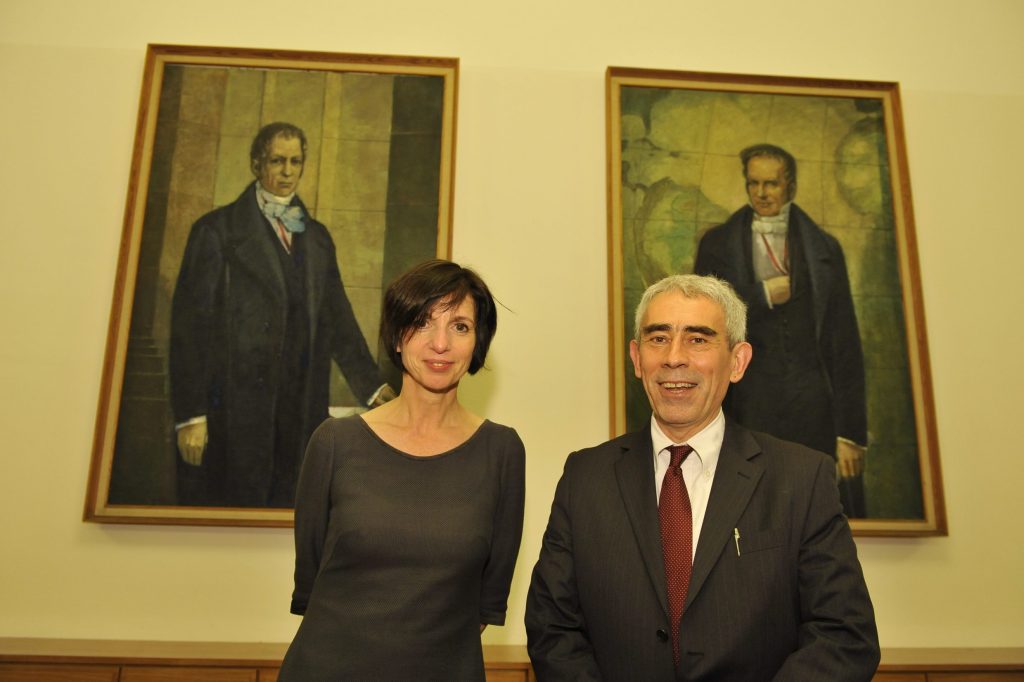 Checchi and Allmendinger pose in front of the portraits of the Humboldt brothers