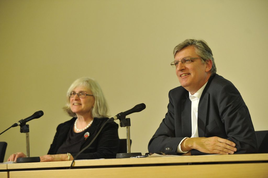 Diner and Müller address the audience