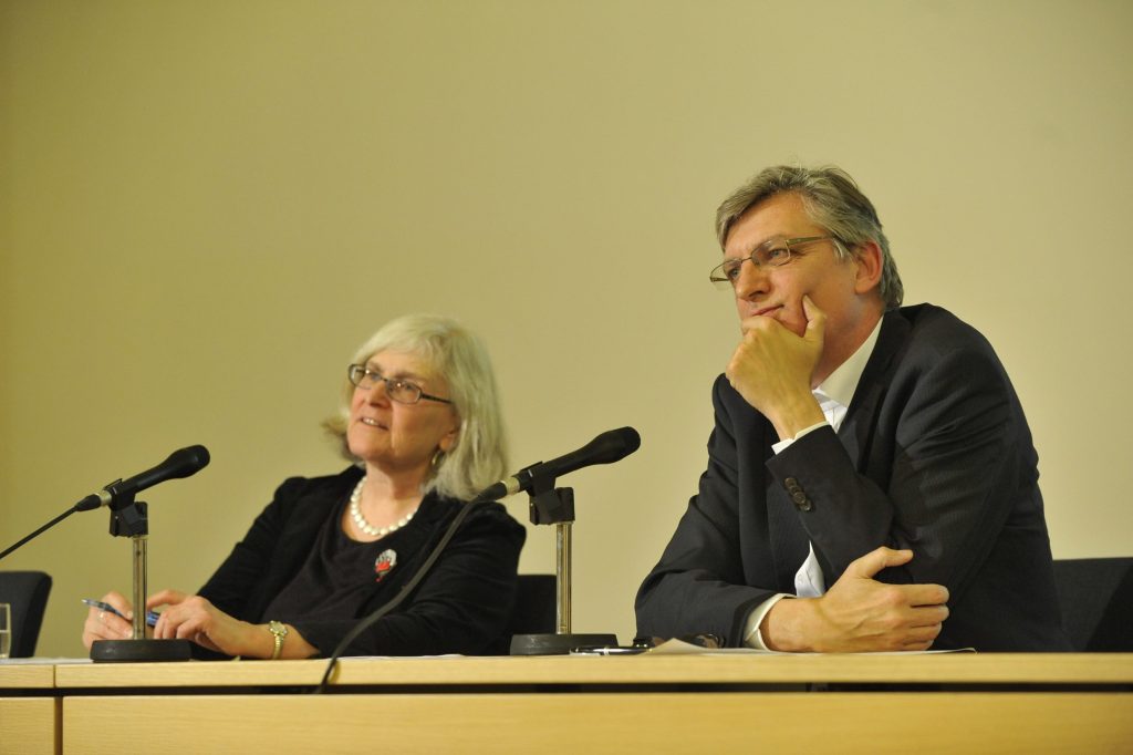 Diner and Müller address the audience