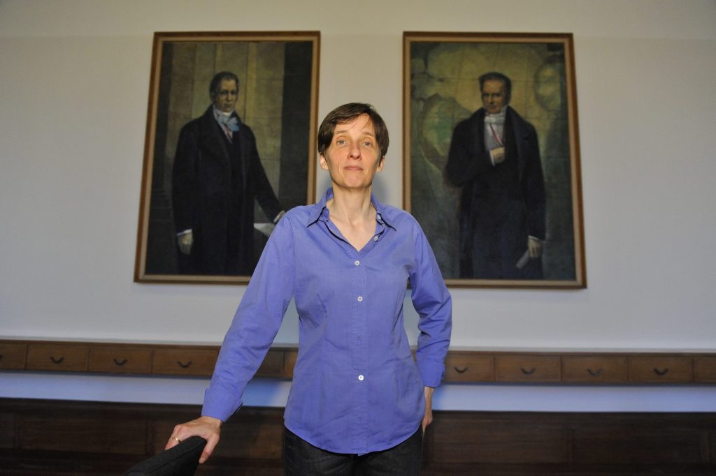 Kennedy poses in front of the portraits of the Humboldt brothers