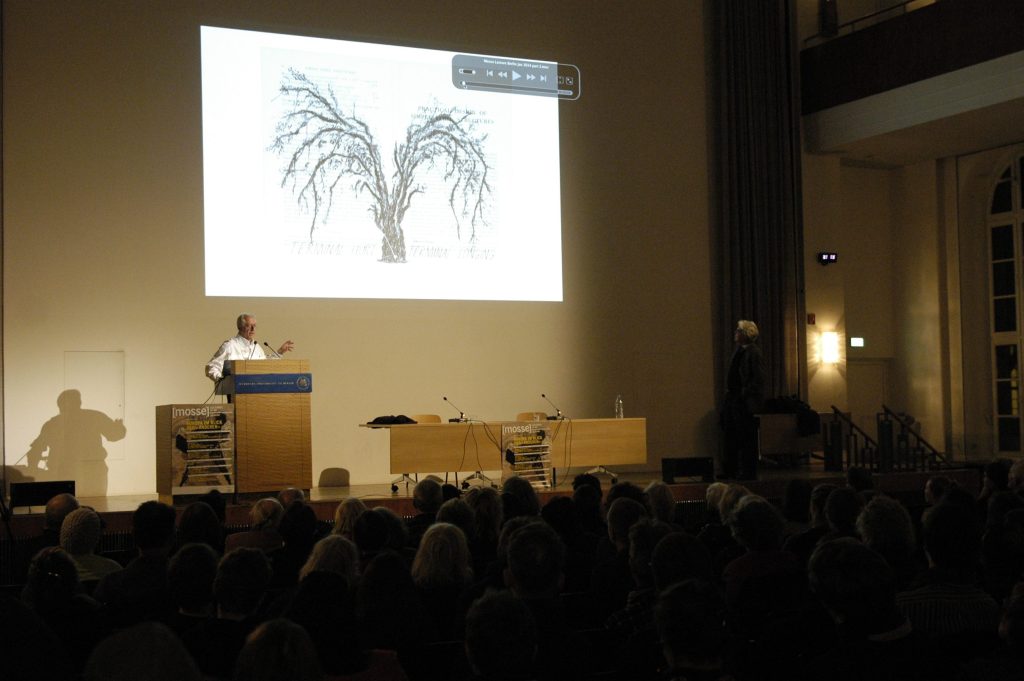 the audience looks at a slide depicting a tree
