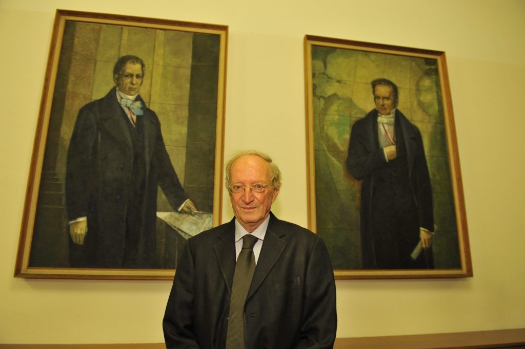 Margalit poses in front of the portraits of the Humboldt brothers