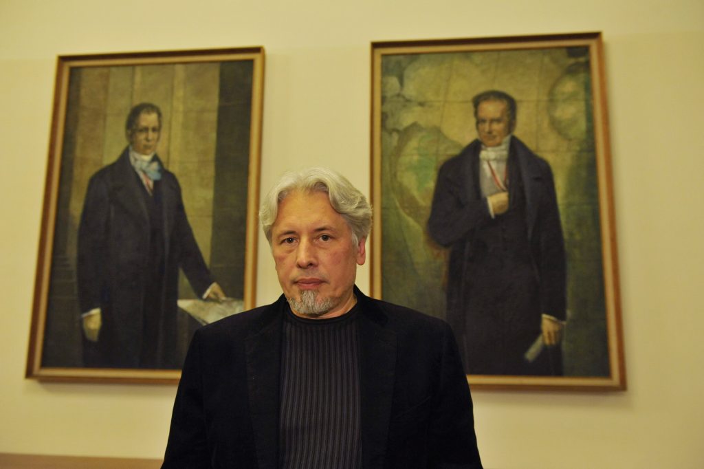 Sorokin poses in front of the portraits of the Humboldt brothers