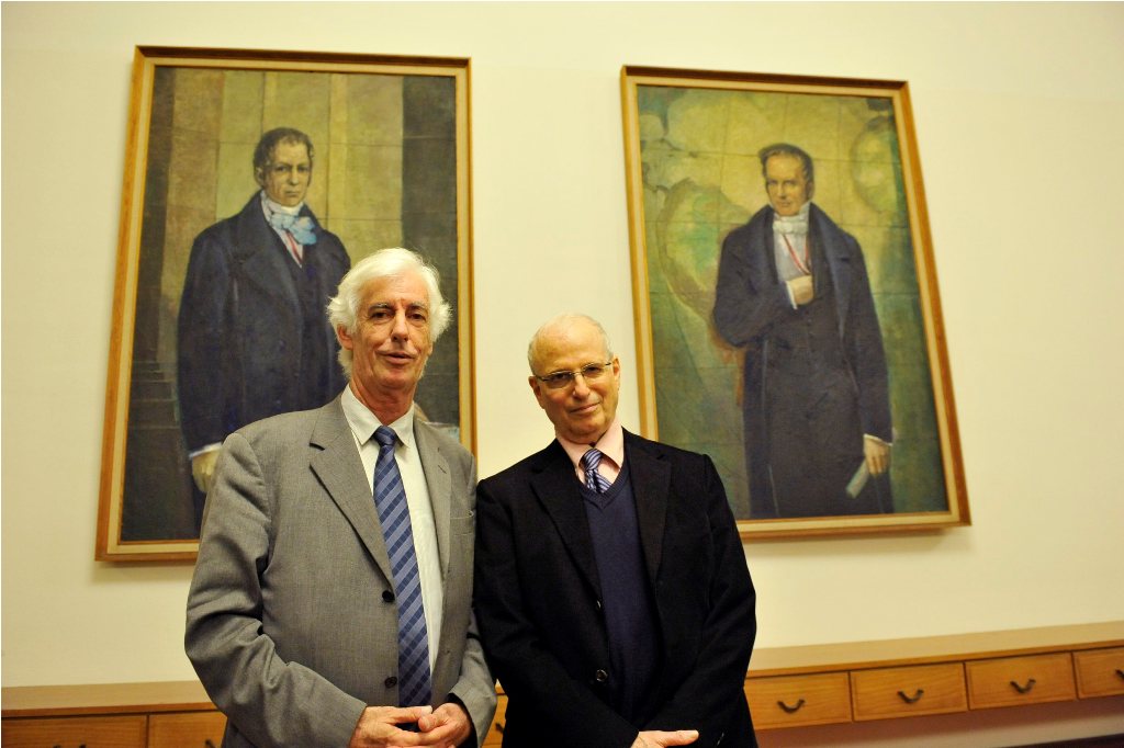 Zimmermann and Ezrahi pose in front of the portraits of the Humboldt brothers